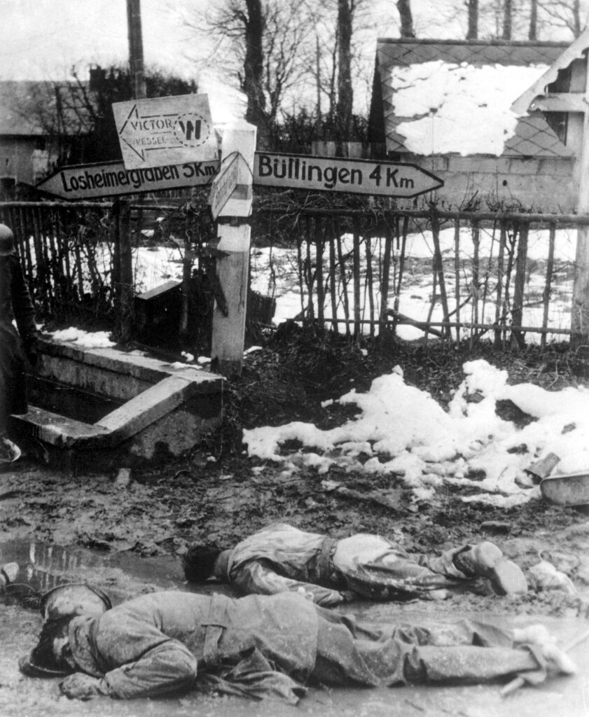 Two dead American soldiers at a road intersection. Photo probably taken at Murringen on December 17, 1914. Source: Wikimedia Commons